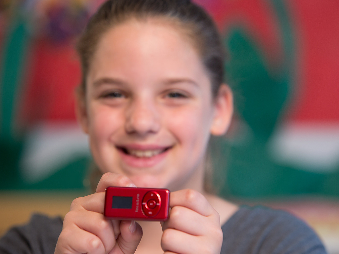 Photo of a student showing off an mp3 player.