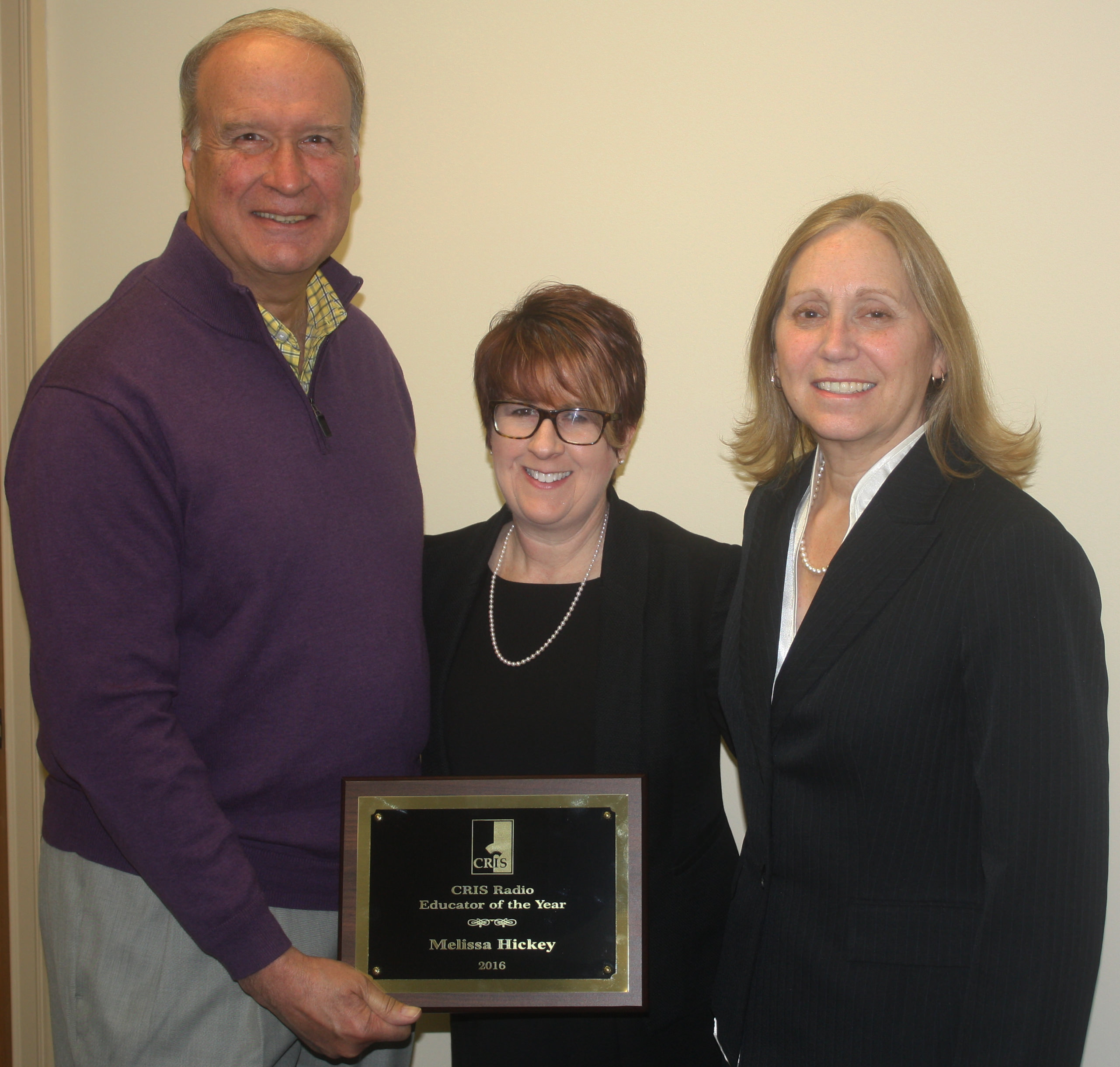 Melissa Hickey, flanked by CRIS Board President Paul Young and Executive Director Diane Weaver Dunne