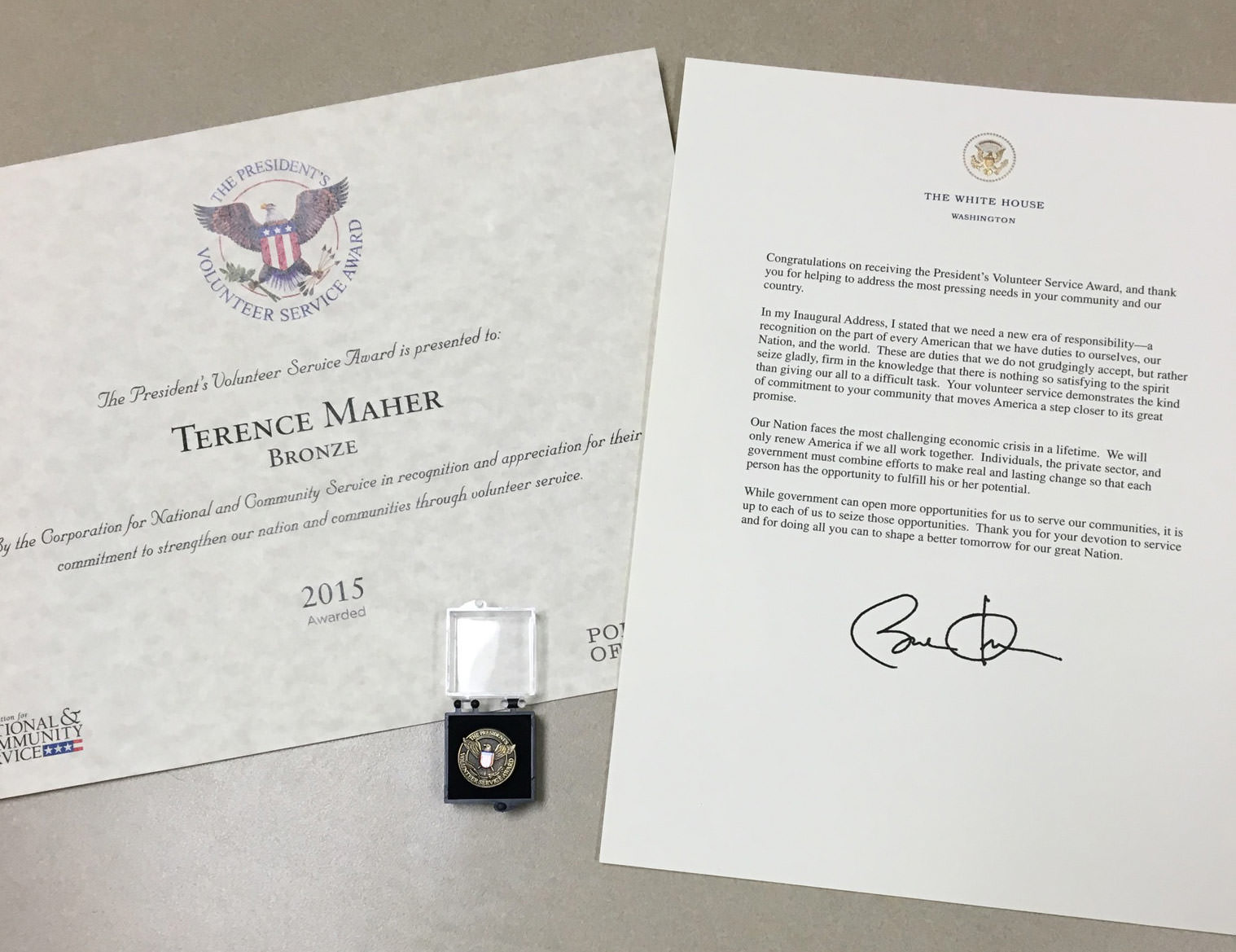 A photo of Terrence's award, medal and congratulatory letter from President Barack Obama.