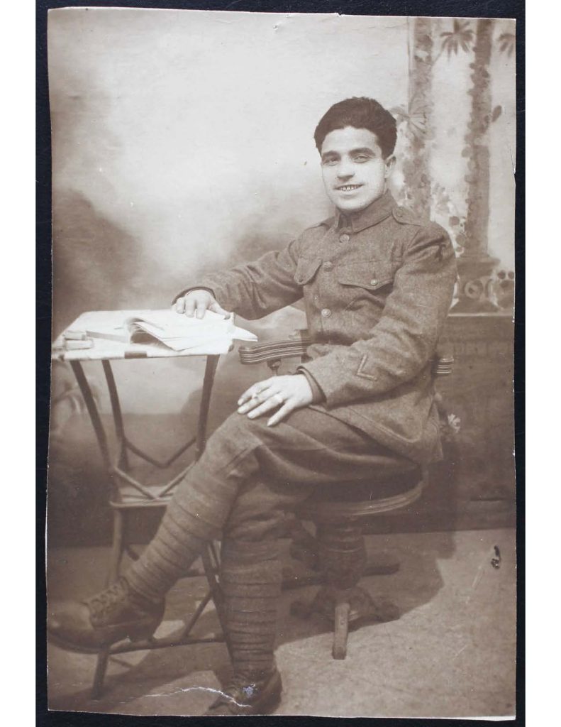 a photo of nicola andreazzi wearing military attire and sitting next to a small table