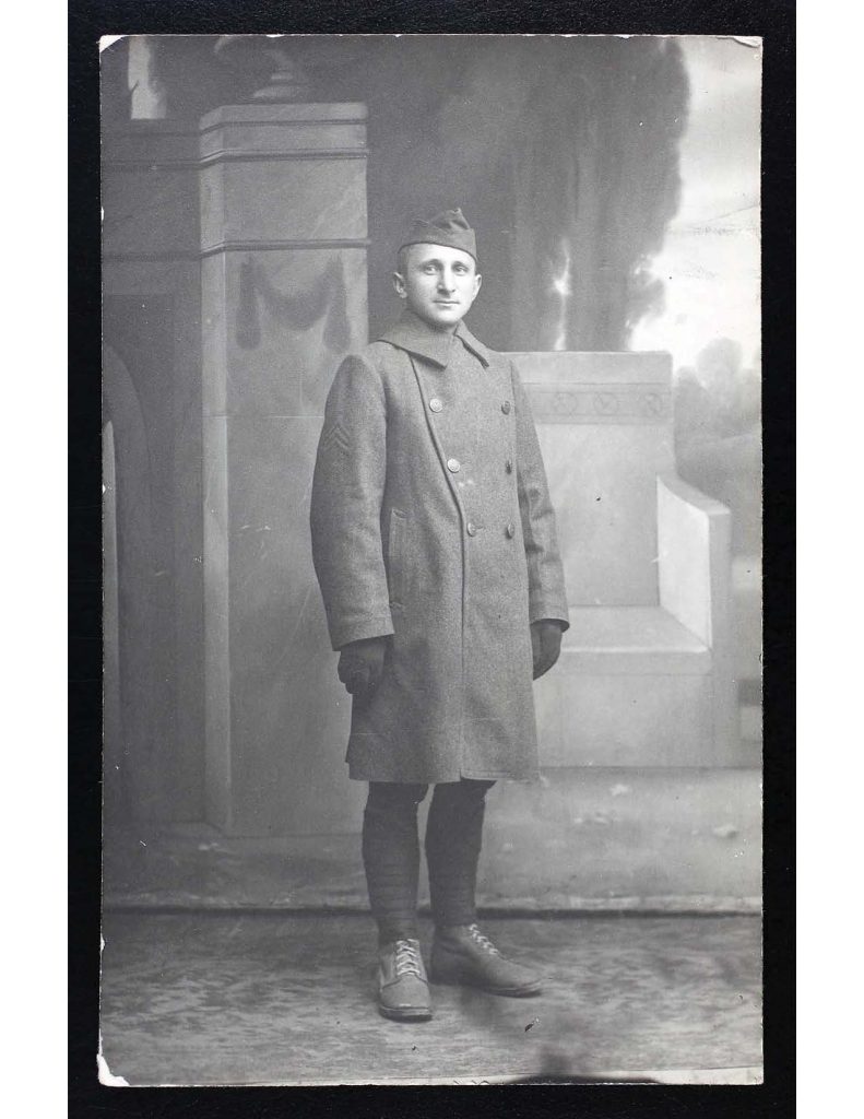 a black and white photo of samule benjamin yaffo wearing his military hat, uniform, and coat